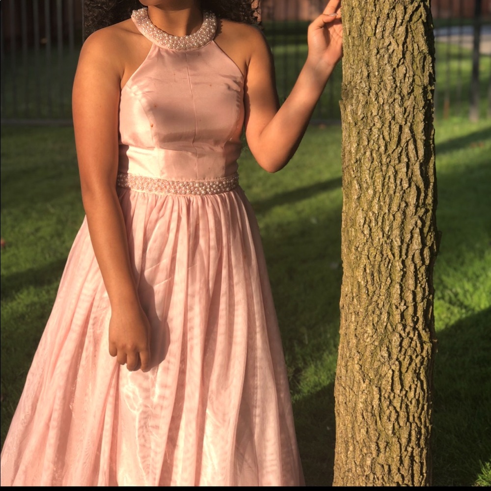 Long pink dress styled with pearls